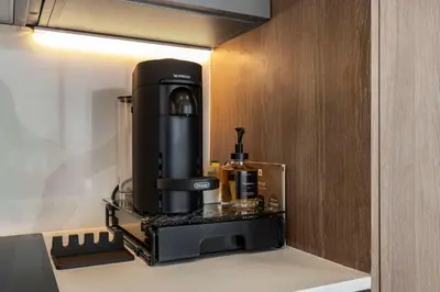 a black coffee maker on a shelf in a kitchen at Ocean Dreams Chic 2BR Getaway Minutes from Miami's Top Attractions in Miami Beach