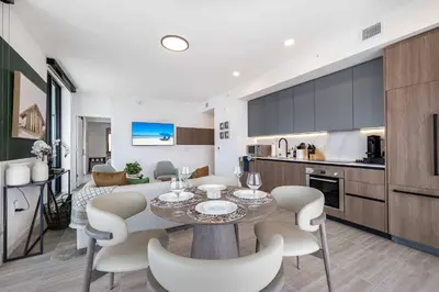 a kitchen and living room with a table and chairs at Ocean Dreams Chic 2BR Getaway Minutes from Miami's Top Attractions in Miami Beach