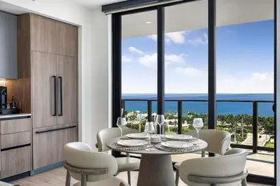 a kitchen and dining room with a table and chairs at Ocean Dreams Chic 2BR Getaway Minutes from Miami's Top Attractions in Miami Beach