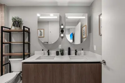 a bathroom with two sinks and a large mirror at Ocean Dreams Chic 2BR Getaway Minutes from Miami's Top Attractions in Miami Beach