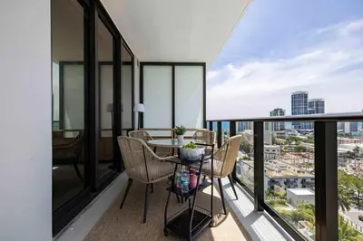 a balcony with a table and chairs and a view at Miami Beach Retreat Cozy 1BR Steps from the Shore in Miami Beach