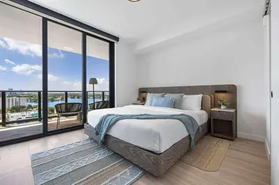 a bedroom with a large bed and a large window at Miami Beach Retreat Cozy 1BR Steps from the Shore in Miami Beach