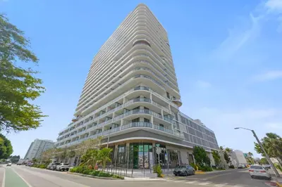 a tall white building on a city street at NOK Fantastic 1 BR Den in Miami in Miami Beach