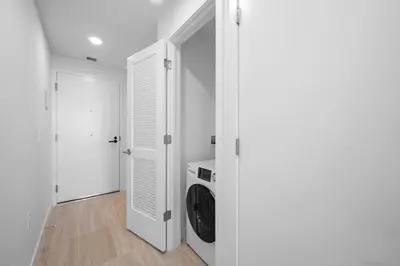 a white hallway with a washing machine in a room at NOK Fantastic 1 BR Den in Miami in Miami Beach