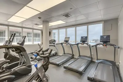 a gym with treadmills and elliptical machines at Oceanfront Resort Condo with Gym and Waterfront Pool! in Sunny Isles Beach