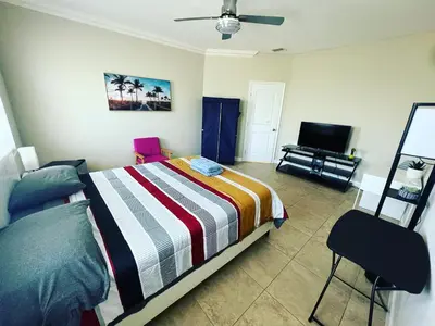 a bedroom with a bed and a flat screen tv at The Garden House in Miami Lakes in Miami Lakes