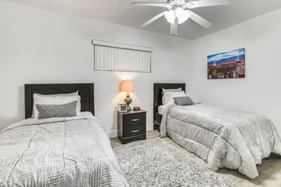 a bedroom with two beds and a ceiling fan at Game Day Made Easy Home 3 Mi to Hard Rock Stadium in Miami Gardens