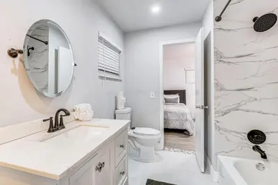 a bathroom with a sink and a toilet and a mirror at Game Day Made Easy Home 3 Mi to Hard Rock Stadium in Miami Gardens