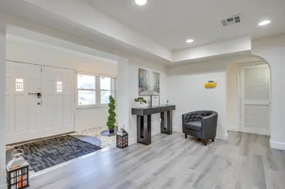 a living room with a desk and a chair at Game Day Made Easy Home 3 Mi to Hard Rock Stadium in Miami Gardens