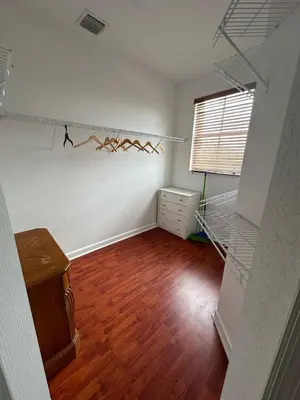 an empty room with a shelf with birds on the wall at The Miami Lakes Pool House in Miami Lakes