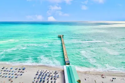 an overhead view of a beach with a group of chairs at Modern 2 bedroom condo with heated pool, free parking spot at a 5 minute walk to the beach! in Sunny Isles Beach