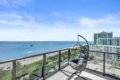a swing on a balcony overlooking the beach at Luxury Oceanfront Condo 2BR 2.5BA with 700Sqft Terrace Sauna Resort Amenities and Pools 1501 in Miami Beach