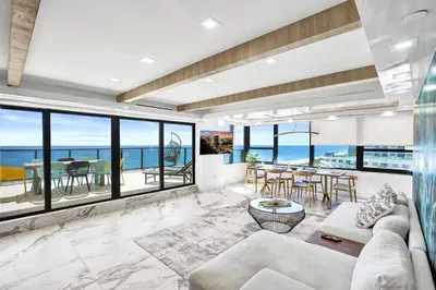 a living room with a view of the ocean at Luxury Oceanfront Condo 2BR 2.5BA with 700Sqft Terrace Sauna Resort Amenities and Pools 1501 in Miami Beach