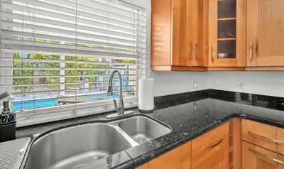 a kitchen with a sink and a window at Casa Verde - Wilton Manors - Pool in Fort Lauderdale