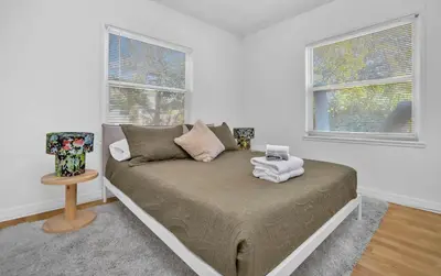 a bed in a room with two windows at Casa Verde - Wilton Manors - Pool in Fort Lauderdale