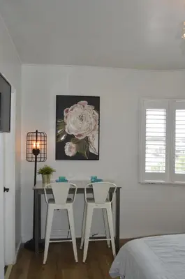a dining room with a table and two chairs at WATERFRONT STUDIO COZY WITH WATERVIEWs in Miami Beach
