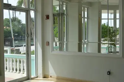 an empty room with a window and a balcony at WATERFRONT STUDIO COZY WITH WATERVIEWs in Miami Beach