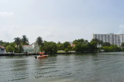 a small boat in the middle of a river at WATERFRONT STUDIO COZY WITH WATERVIEWs in Miami Beach