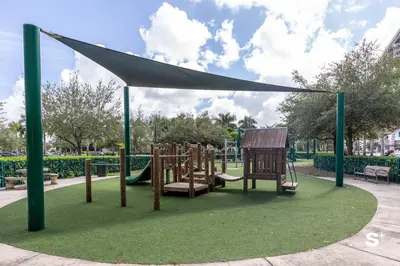 a playground in a park with a white canopy at Studio Apt in Downtown Doral in Miami