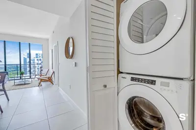 a washer and dryer in a room with a balcony at Modern 1BR in Downtown Doral - Free Parking and Wellness Amenities in Miami