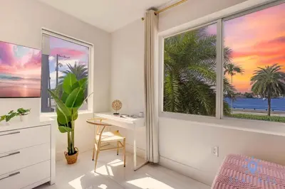 a bedroom with a desk and a window with a view of the ocean at 809 Complex in Hollywood
