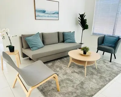a living room with a couch and a table and chairs at Palm Breeze Getaway in Hollywood
