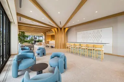 a lobby with blue chairs and tables and a whiteboard at Newest & Elegant Condo - 72 Park in Miami Beach