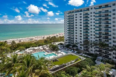 an aerial view of a building and the beach at Stunning Oceanfront 1BR in the 1 Hotel in Miami Beach
