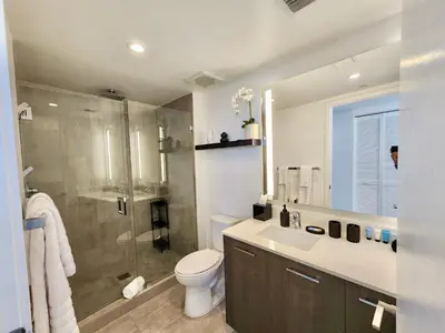 a bathroom with a shower and a toilet and a sink at 3BR Skyline Luxury with a 100 inch TV, Balcony & Prime Miami Location in Miami