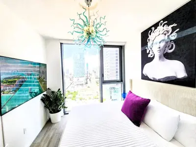 a bedroom with a bed and a large window at 3BR Skyline Luxury with a 100 inch TV, Balcony & Prime Miami Location in Miami
