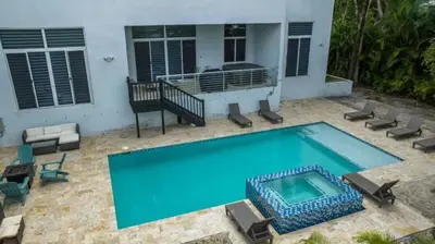 a swimming pool in front of a house at Villa Azul Luxe Retreat in Fort Lauderdale