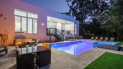 a house with a swimming pool in front of a house at Villa Azul Luxe Retreat in Fort Lauderdale