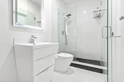 a white bathroom with a toilet and a shower at Brand new Luxurious Villa in Hollywood