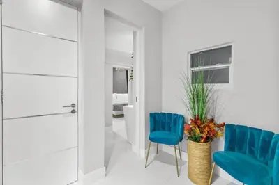 a room with two blue chairs and a door at Brand new Luxurious Villa in Hollywood