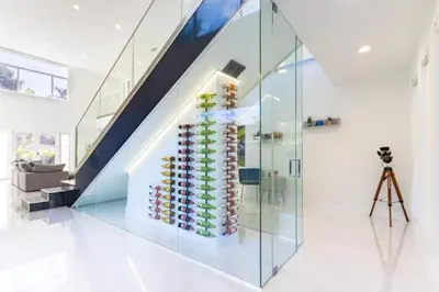 a wall of wine bottles in a room with a staircase at Brand new Luxurious Villa in Hollywood