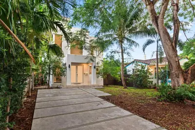 a walkway in front of a house with palm trees at One and only New Villa Heated Pool Jacuzzi in Hollywood
