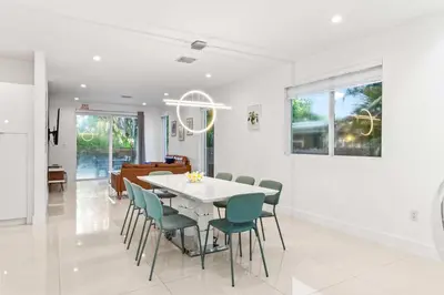 a dining room with a white table and chairs at One and only New Villa Heated Pool Jacuzzi in Hollywood