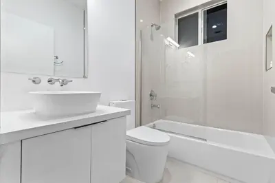 a white bathroom with a sink and a toilet and a shower at One and only New Villa Heated Pool Jacuzzi in Hollywood