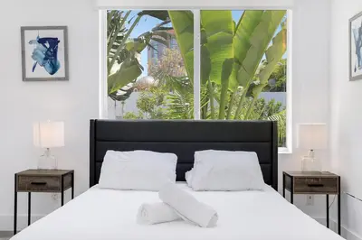 a bedroom with a bed with white sheets and a window at St Augustine Hotel By At Mine Hospitality in Miami Beach