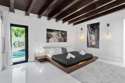 a bedroom with a large bed in a white room at New Construction Villa Top Location Jacuzzi Bkb CT in Miami
