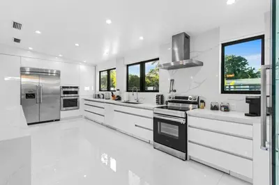 a white kitchen with stainless steel appliances and windows at New Construction Villa Top Location Jacuzzi Bkb CT in Miami