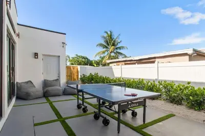 a ping pong table on a patio in a backyard at New Construction Villa Top Location Jacuzzi Bkb CT in Miami