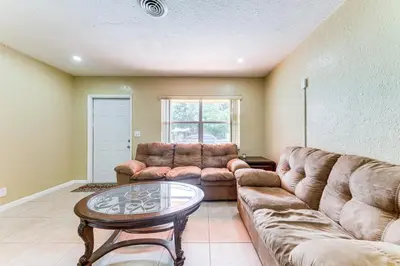 a living room with a couch and a table at 3 Mi to Dania Beach Pier Convenient Apartment! in Dania Beach