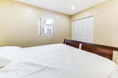a bedroom with a white bed and a window at 3 Mi to Dania Beach Pier Convenient Apartment! in Dania Beach