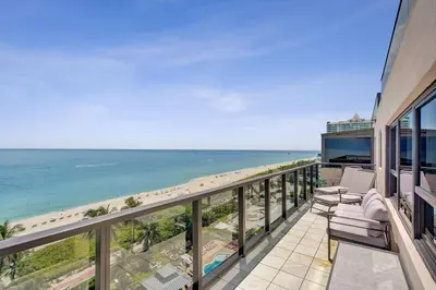 a balcony with a view of the beach at Stylish Oceanfront 2BR 1 and a half BA Condo with Resort Amenities Pools Gym Sauna 1402 in Miami Beach