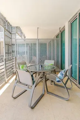 a dining room with a table and chairs on a balcony at Luxury Suite - 3 Min Walk to Miami Beach in Miami Beach
