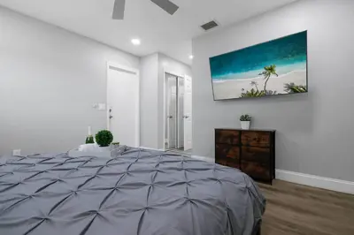 a bedroom with a large bed and a painting on the wall at Renovated Home in Hollywood in Hollywood