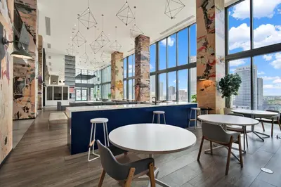 a cafeteria with tables and chairs and large windows at Elegant studio in the heart of downtown Miami in Miami