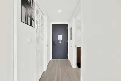 a hallway with a black door and white walls at Elegant studio in the heart of downtown Miami in Miami