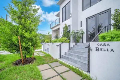 a white house with a sign that reads casa belilia at Casa Bella - New & Stylish Family-Friendly Home in Miami